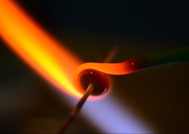 Annie McCabe at her lampwork torch, shaping molten glass