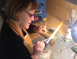 Annie McCabe at her lampwork torch, shaping molten glass